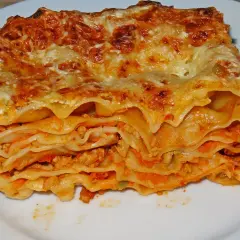 Ein Stück Lasagne mit Hackfleisch, geschichtet mit Nudelplatten und Tomatensauce, überbacken mit Käse.